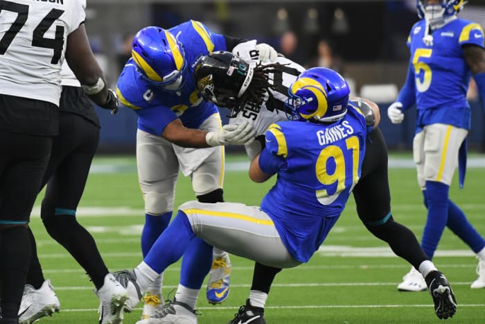 Dec 5, 2021; Inglewood, California, USA; Los Angeles Rams defensive end Aaron Donald (99) and defensive end Greg Gaines (91) tackle Jacksonville Jaguars wide receiver Laviska Shenault Jr. (10) in the fourth quarter at SoFi Stadium. Mandatory Credit: Richard Mackson-USA TODAY Sports